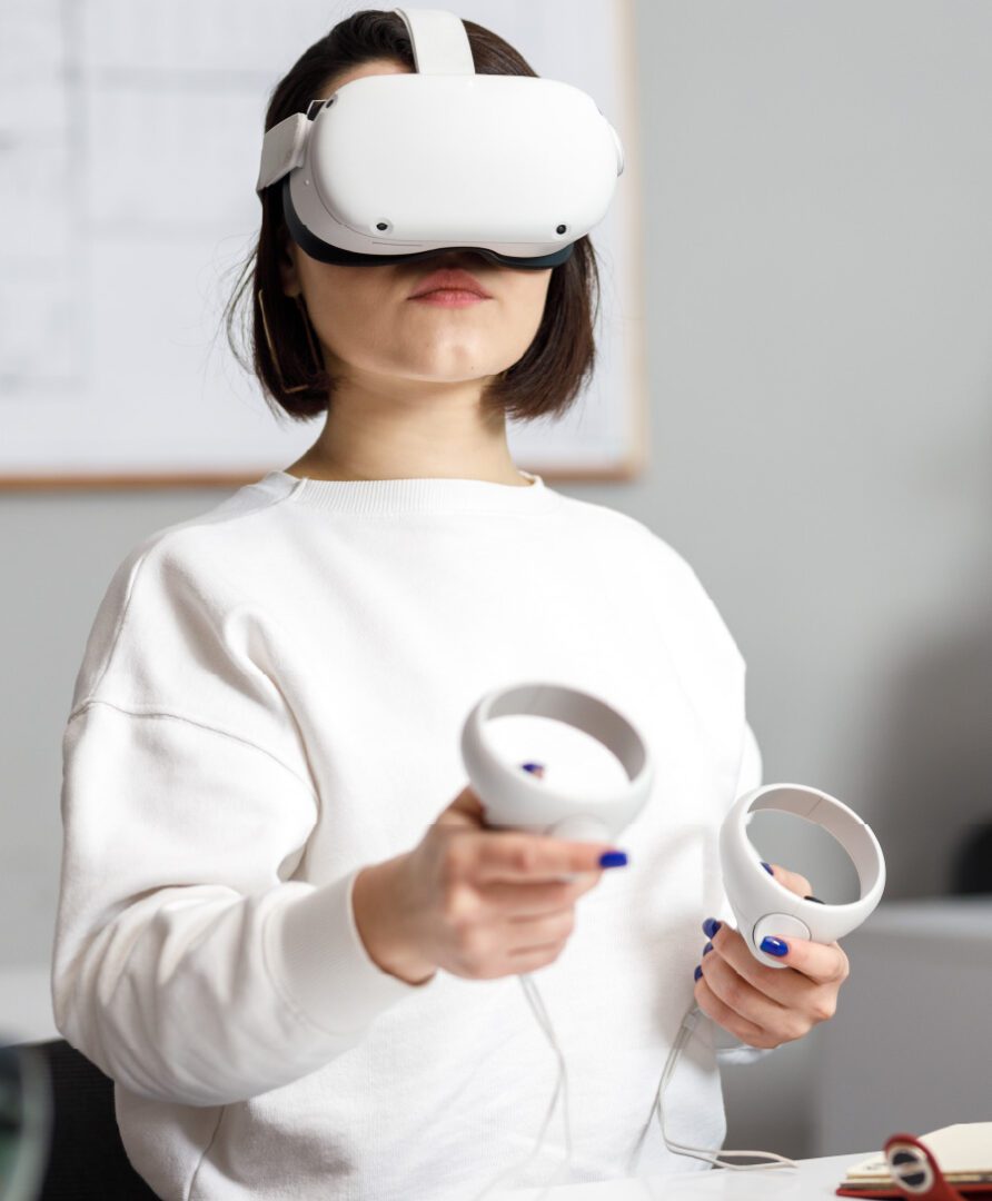 woman working with VR headset on, link to VR room design Services
